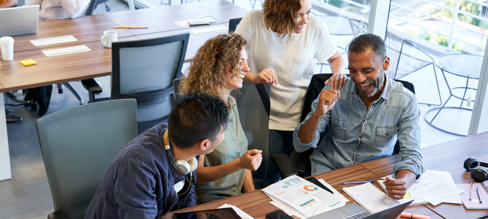 People in an office smiling and laughing