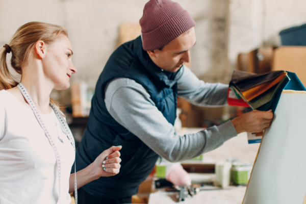 Two people looking at fabrics for office furniture