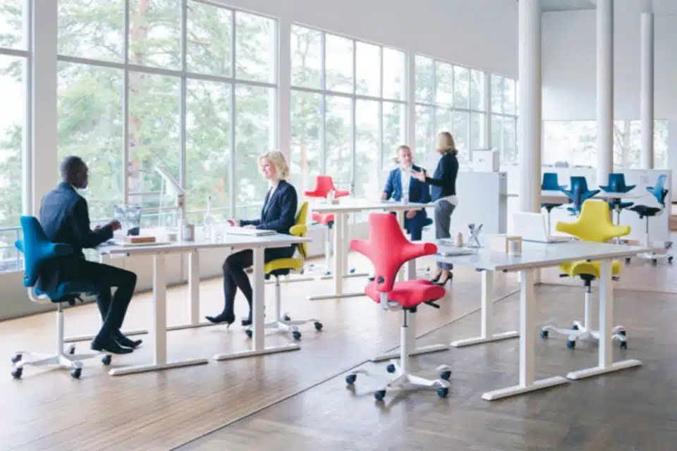 A large spacious room with several brightly coloured ergonomic chairs.