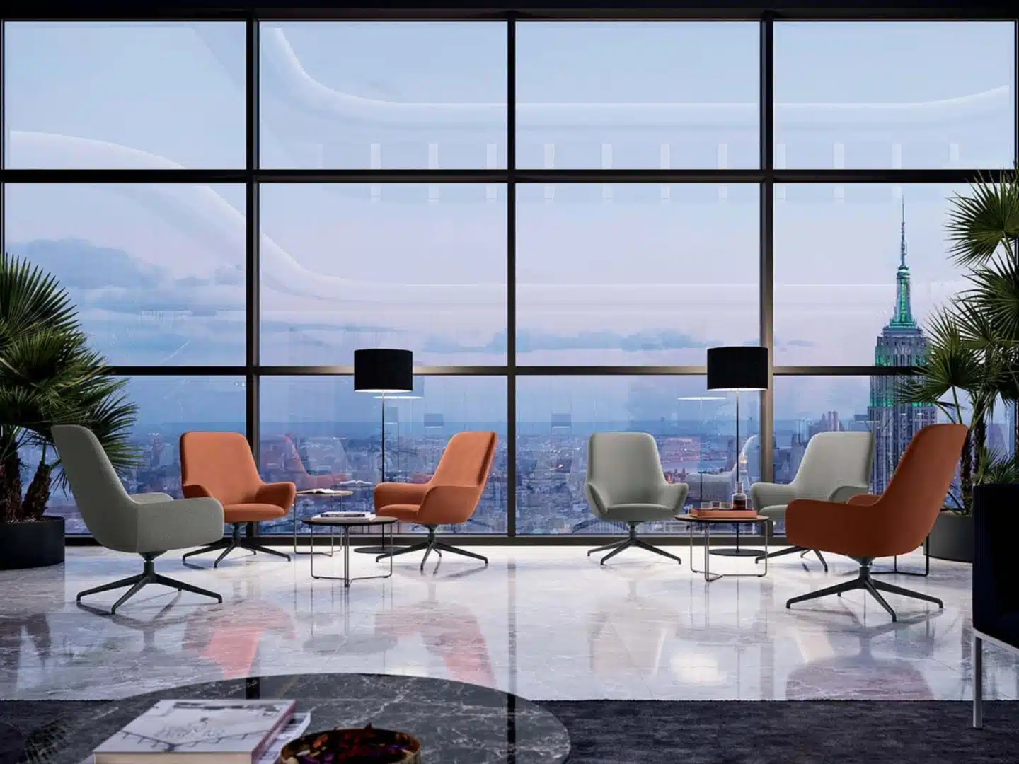 Modern grey and orange lounge sofas in an open-plan office with a large floor-to-ceiling window in the background.