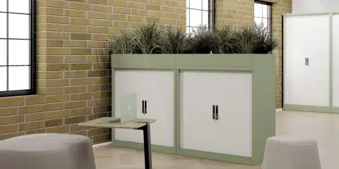 A green and white steel storage cabinets in a spacious and light office.