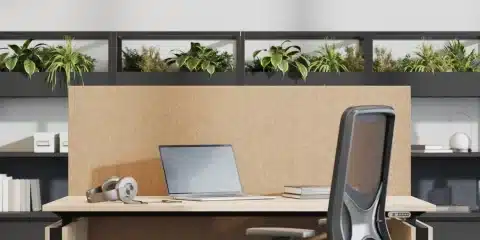 A sit stand single wooden desk with computer and chair.