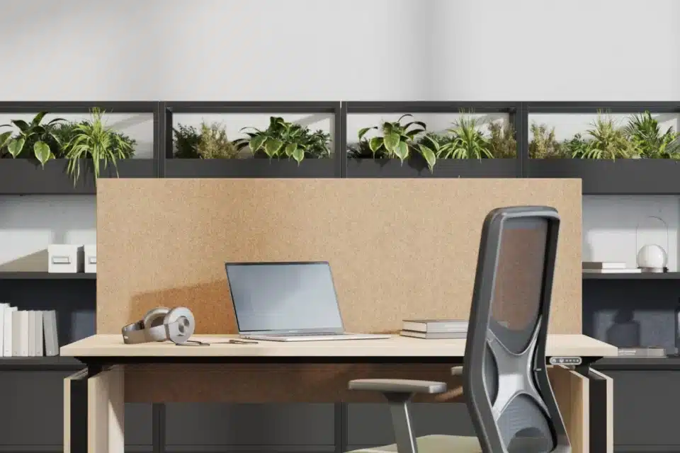 A sit stand single wooden desk with computer and chair.