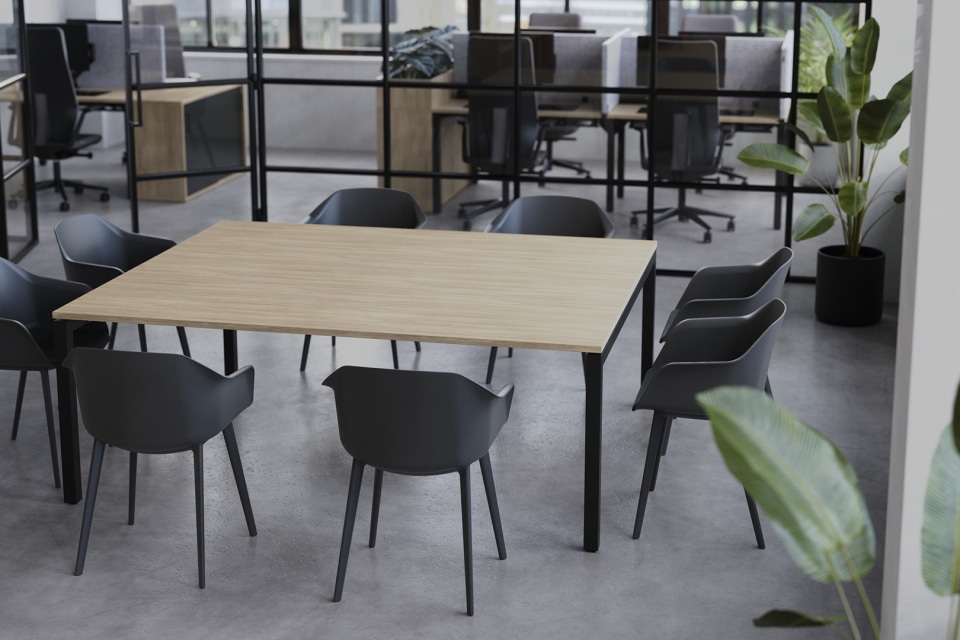 Modern Boardroom with Long Table, Window, and Plant.