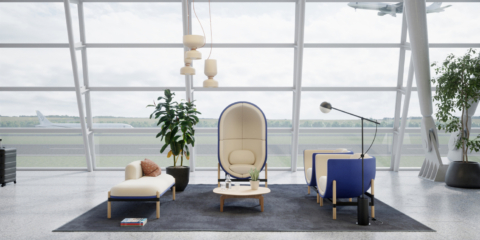 Cream and dark blue, egg shaped pod placed in a large waiting room with a huge window behind.