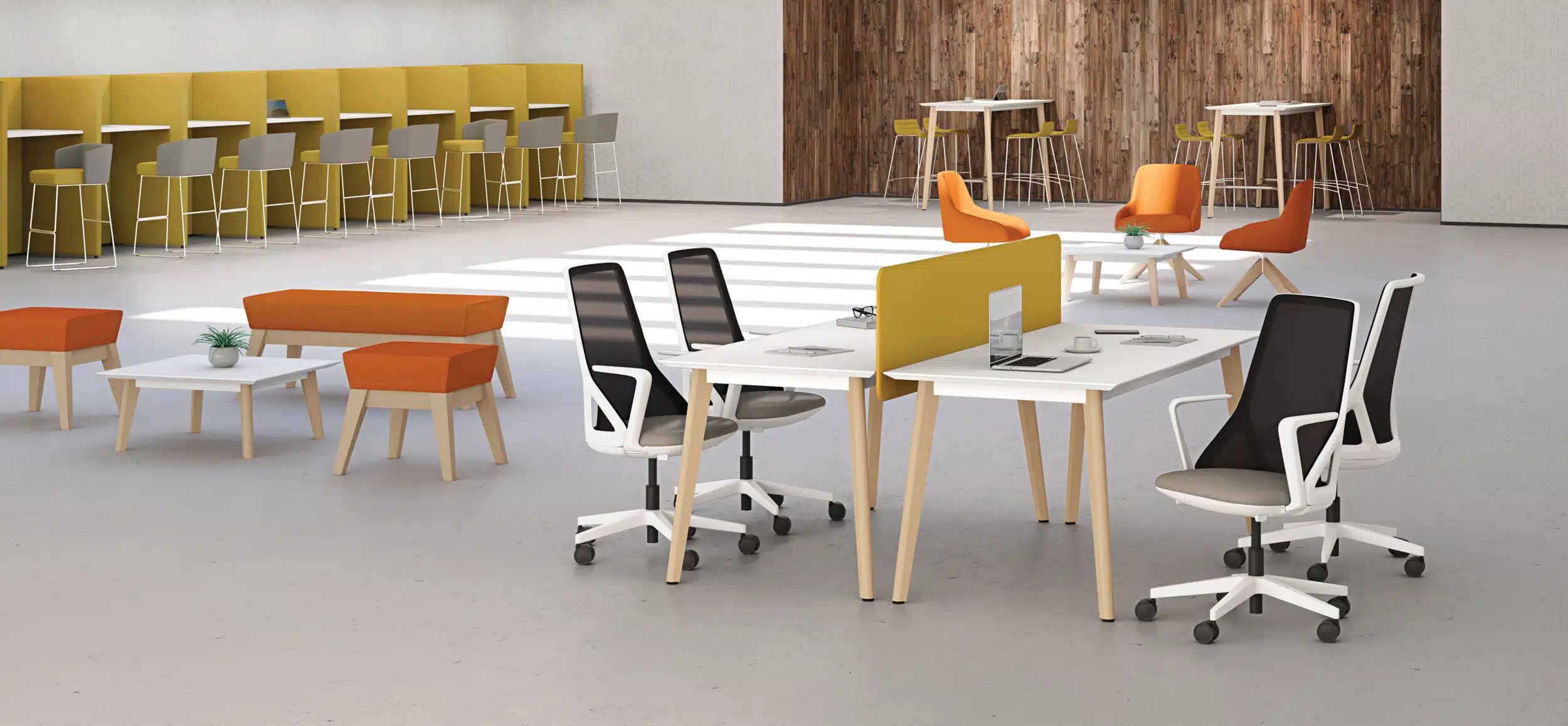 Bench desk wooden style tables in a large room with white office chairs.