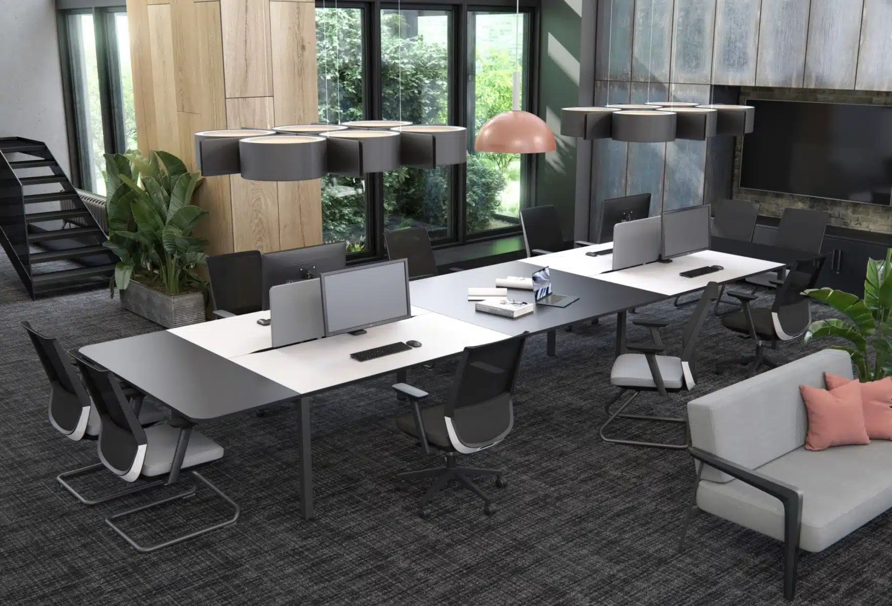 Modern office with two long desks, office chairs, a couch, and unique pendant lighting.