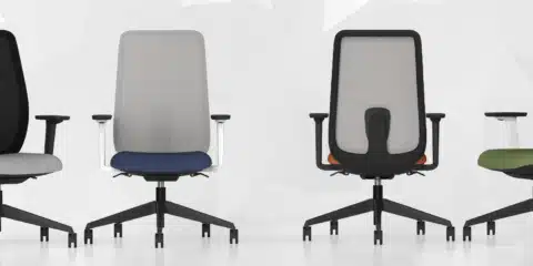 Four black and grey office chairs positioned next to each other.