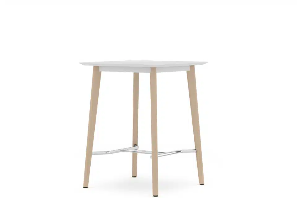 A white top table with wooden legs in an empty room.