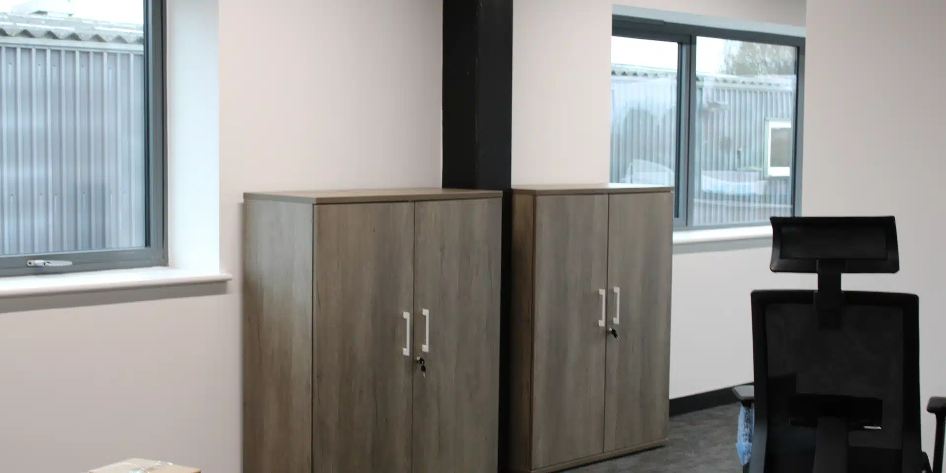 Dark wood office cupboards.