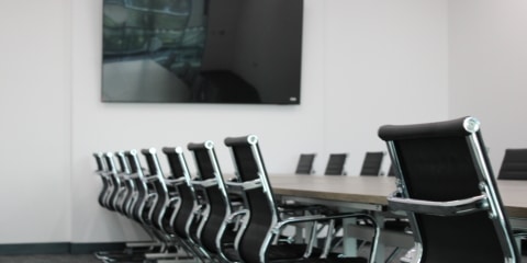 An office room with boardroom chairs.