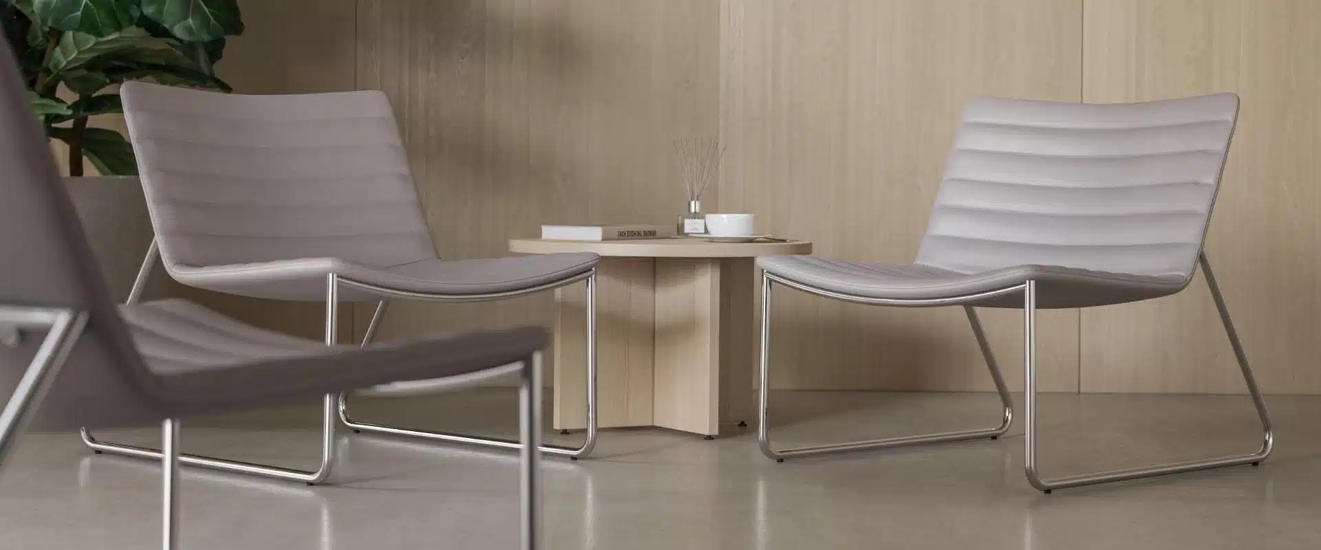 A coffee table next to two high lounge chairs.