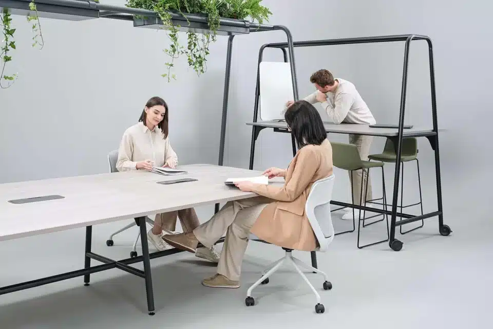 A room with a standard and high table with a green planter above.