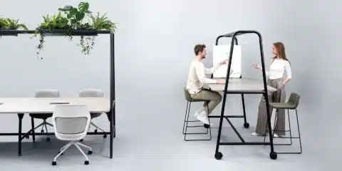 A room with a standard table and a high top table and chairs.