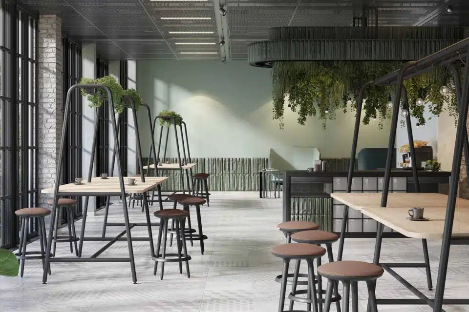 An industrial style room with high tables and planters above.