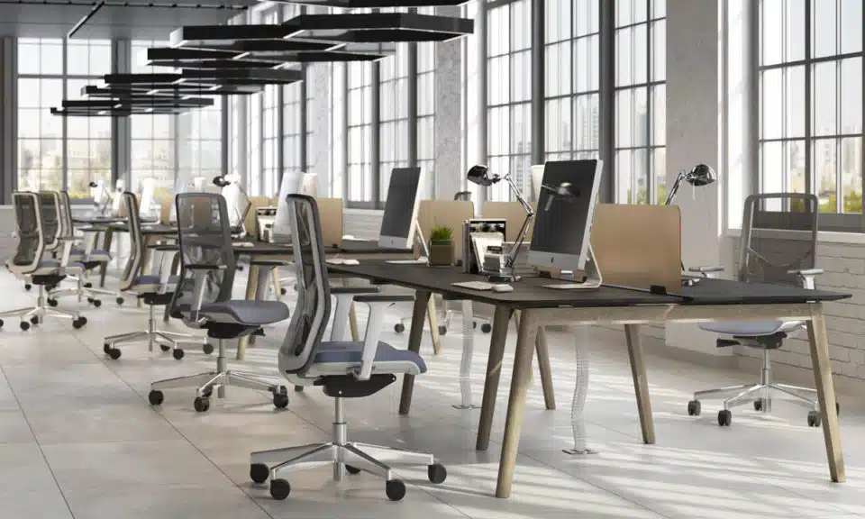 Several wooden desks in open plan office space.