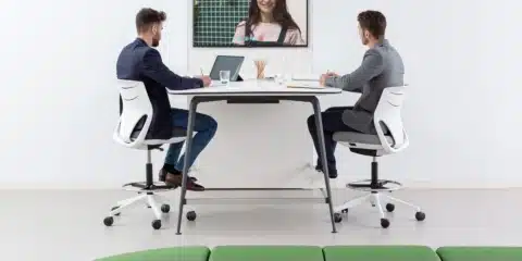 A modern desk in a spacious white office.