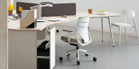A grey room with a white office desk and a chair.