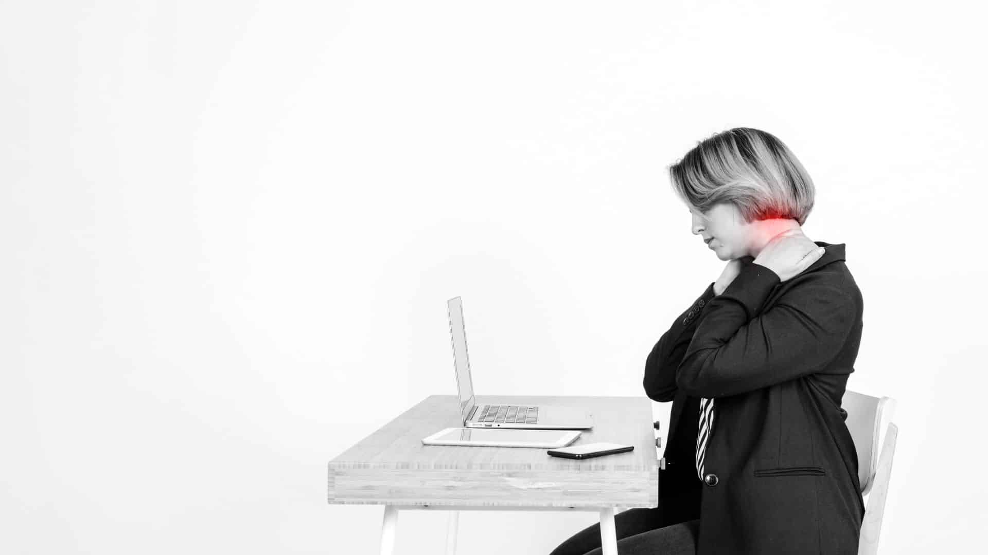A woman-with-sore-neck-using-laptop.