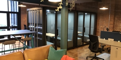 A large container style acoustic pod placed in the open plan office.