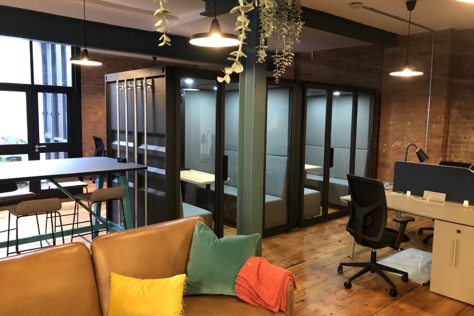 A large container style acoustic pod placed in the open plan office.