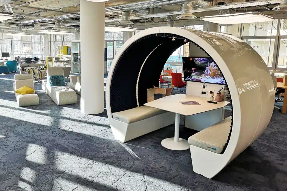A large room with three white pods.