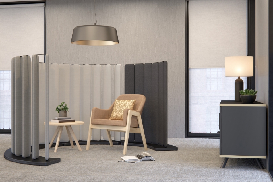 Black and white curved acoustic floor screens with lounge chairs.