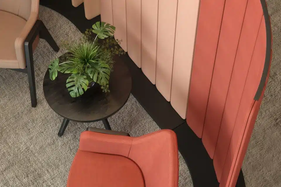 Colorful acoustic floors screens next to lounge chairs.