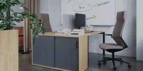 A storage locker system with planters and office chair.