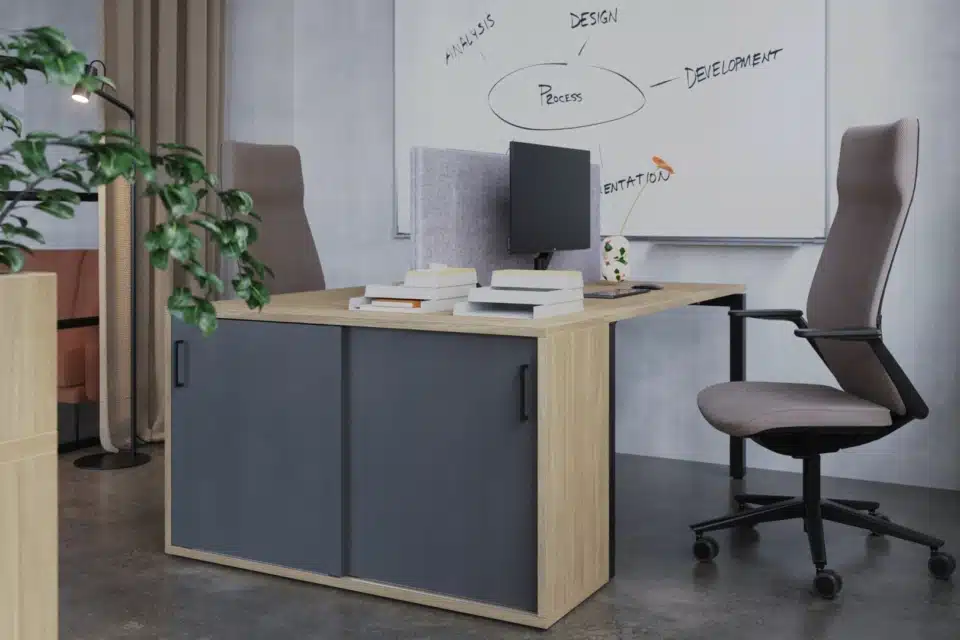A storage locker system with planters and office chair.