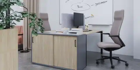A storage cabinet attached to office desk with an office chair.