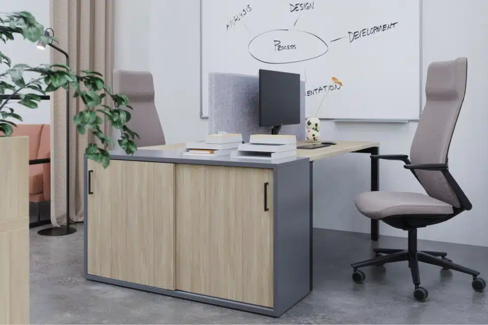 A storage cabinet attached to office desk with an office chair.