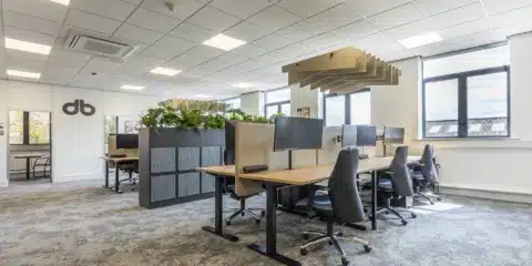 Several Alto 1 high standing desks placed in a room with ergonomic chairs.