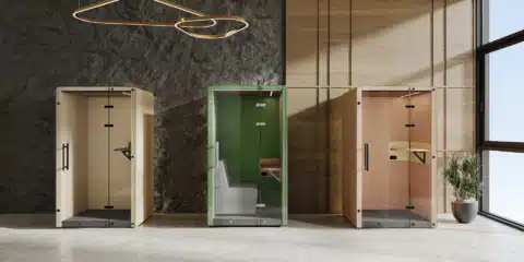 Three colored booths, one yellow, one green, and one orange, are arranged in a row in a lifestyle image.