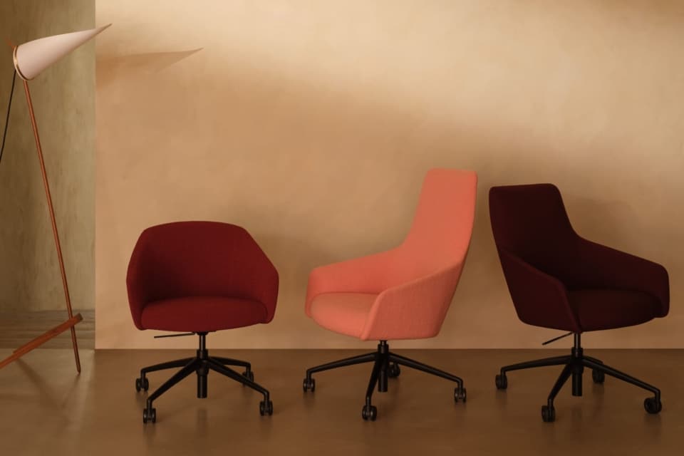 Elegant dining or meeting nook with four upholstered mid-century modern swivel chairs and a round black table.