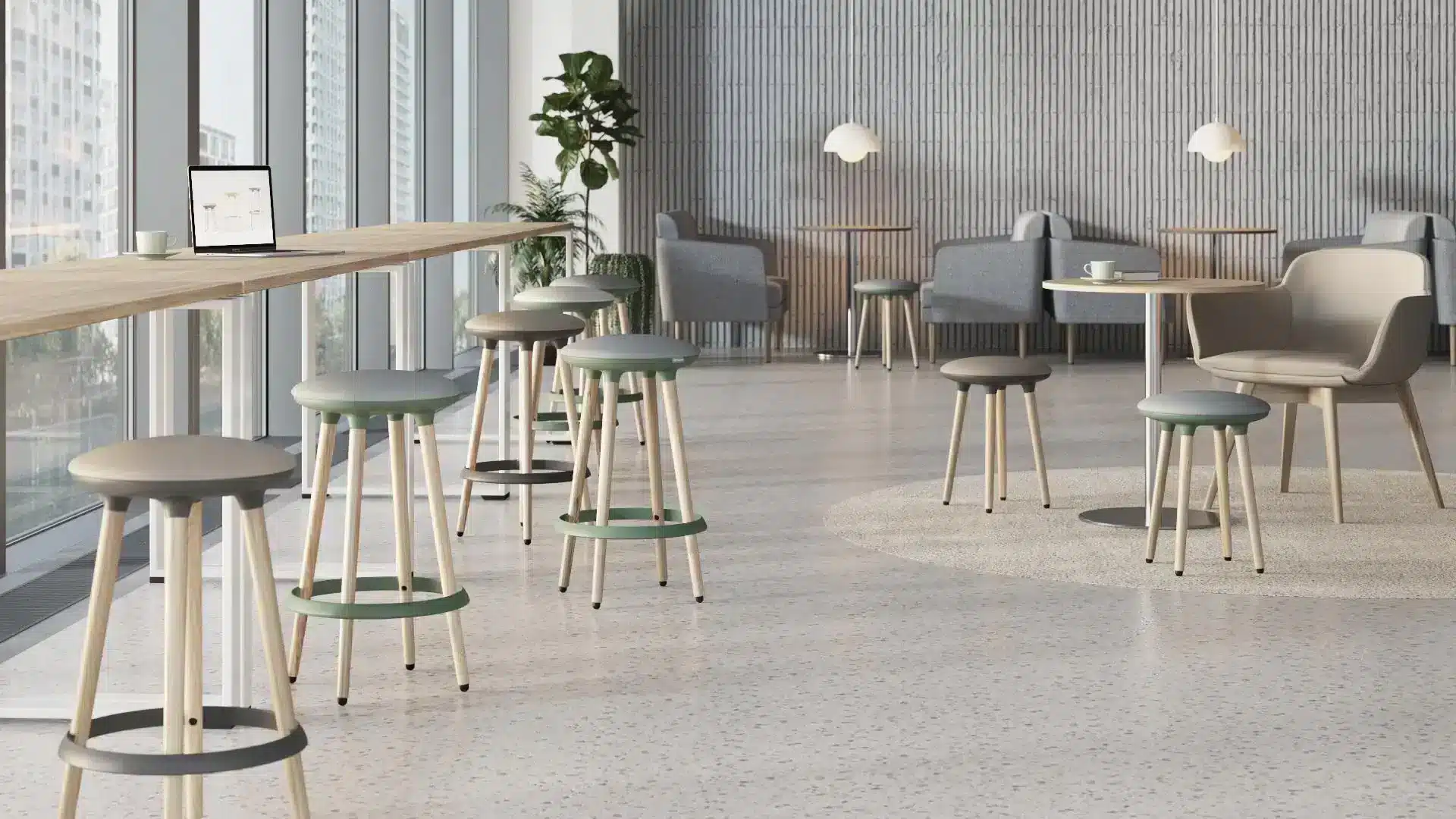Two modern, high-legged stools with green and grey cushioned seats and light wooden legs stand in a bright, open waiting room.