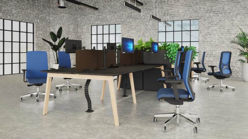 Kardo Boost power system and Desktop Power TI desk module integrated into a Nova-Wood desk, next to Metalicon Kardo Pole Mounted Twin Monitor Arms.