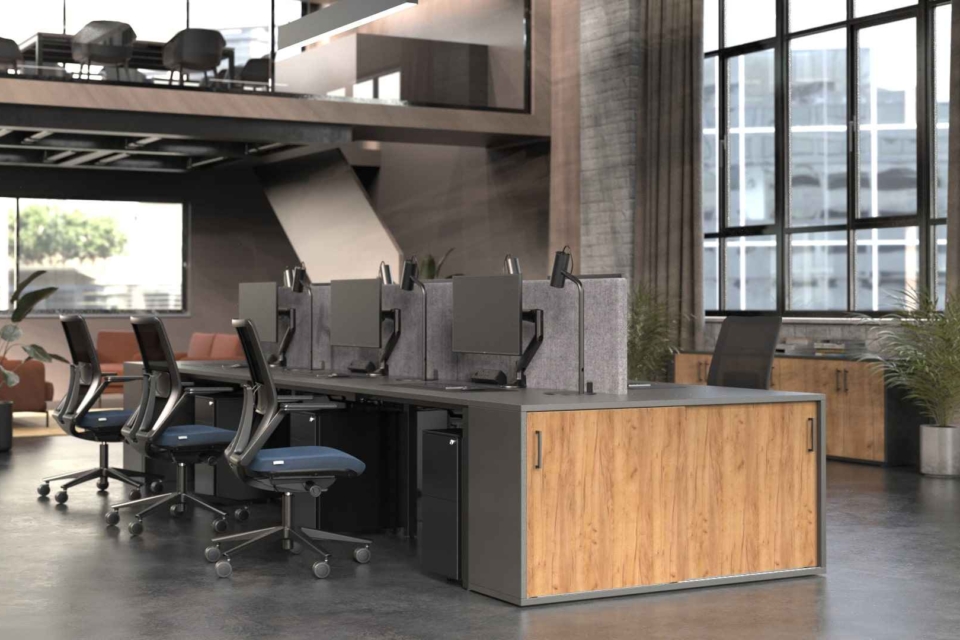 Modern office with SYSTM bench desking, acoustic screens, integrated storage, and a mezzanine level. Large windows reveal a cityscape. Plants add greenery to the space.