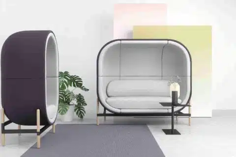 Casala Capsule acoustic office work pod, fully upholstered in blue and grey, in a modern open-plan office setting.