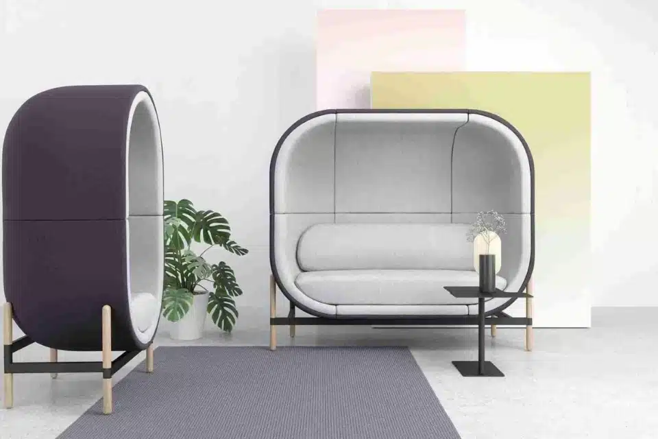 Casala Capsule acoustic office work pod, fully upholstered in blue and grey, in a modern open-plan office setting.