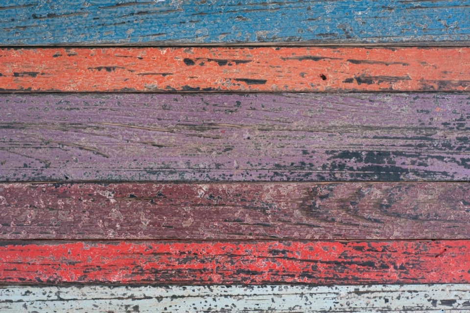 Weathered Rustic Wood Planks with Peeling Bright Paint.