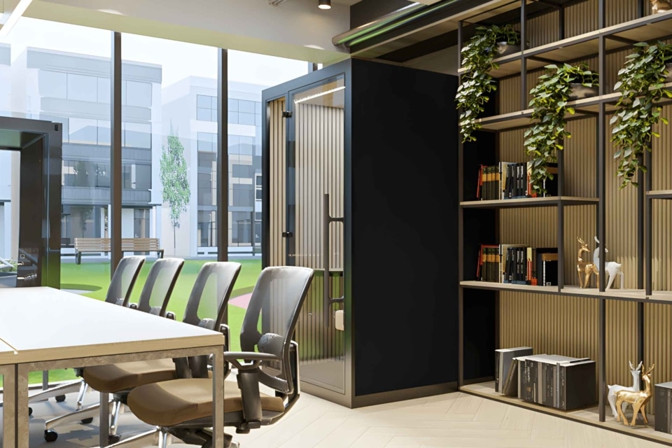 An indoor work booth with integrated storage and adjacent planters.