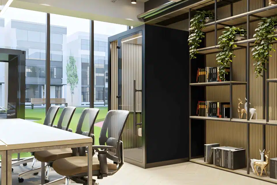 An indoor work booth with integrated storage and adjacent planters.