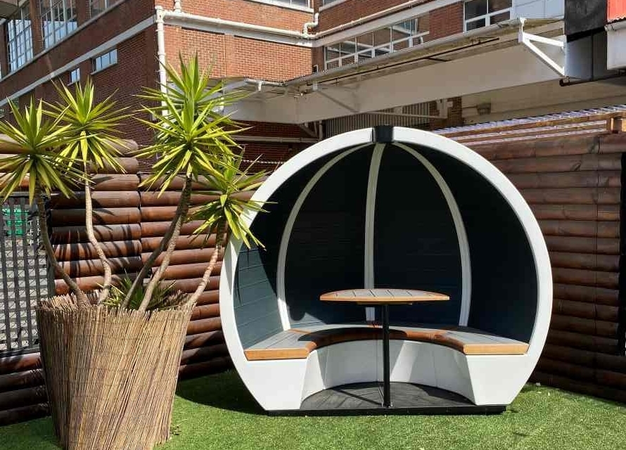 These weatherproof, white Outdoor Orb pods blend perfectly with modern architecture and green spaces.