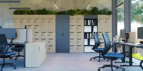 A modern wall of smart office lockers in a hallway, featuring different coloured doors.