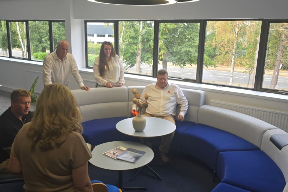 Colleagues gather in a contemporary setting.