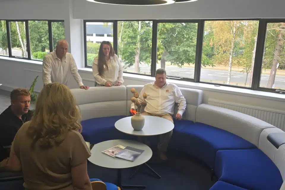Colleagues gather in a contemporary setting.