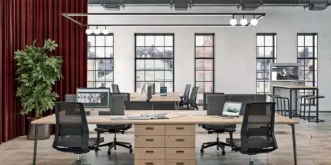 Open-plan office featuring two X3 bench desks with light wood tops.