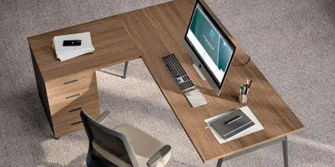 Collaborative X3 desks in a bright room with screens and divider panels.