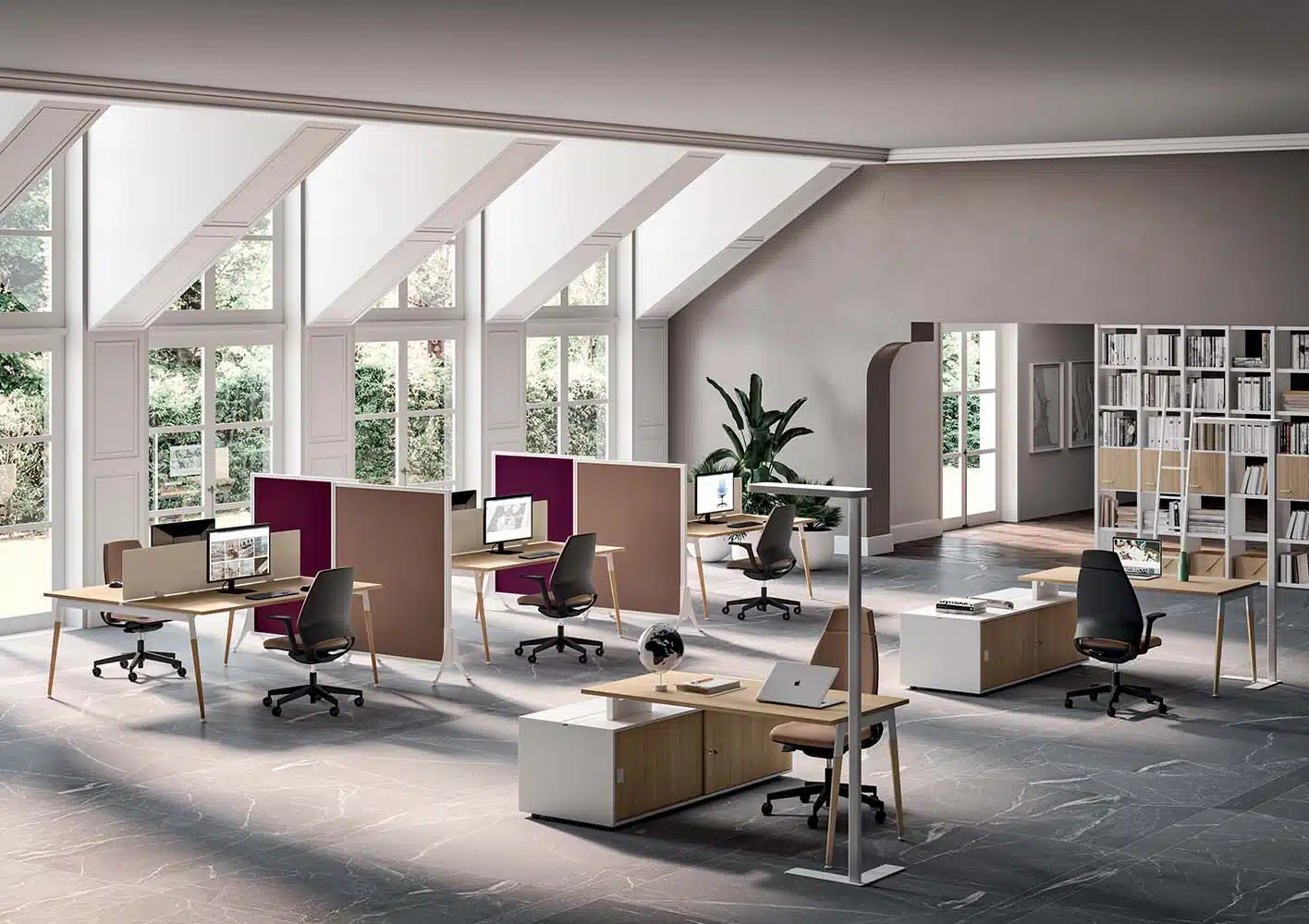 Collaborative X3 desks in a bright room with screens and divider panels.